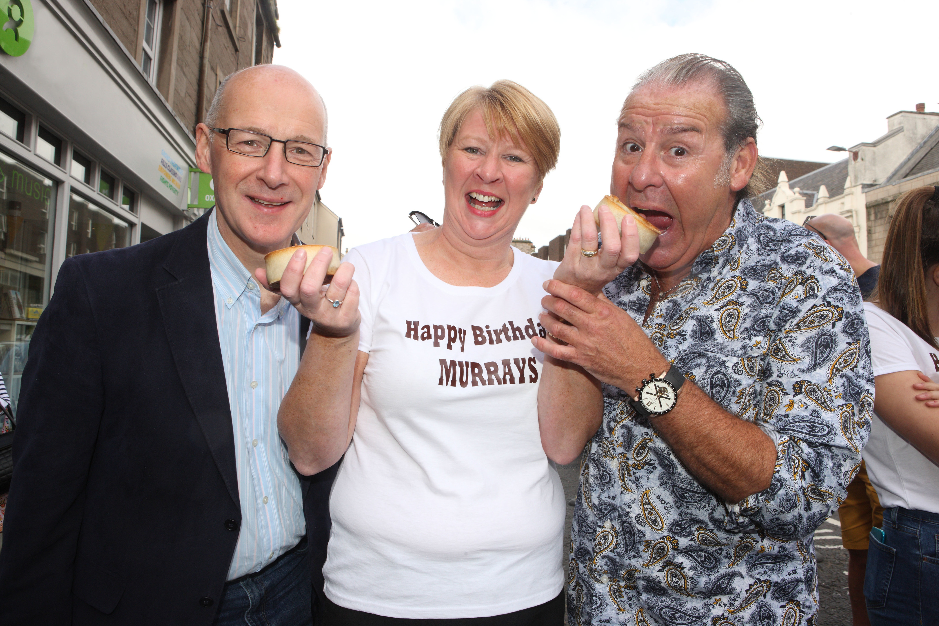 John Swinney and actor Andy Gray help celebrate 115 years of Murrays the Bakers in Perth, with owner Linda Hill.