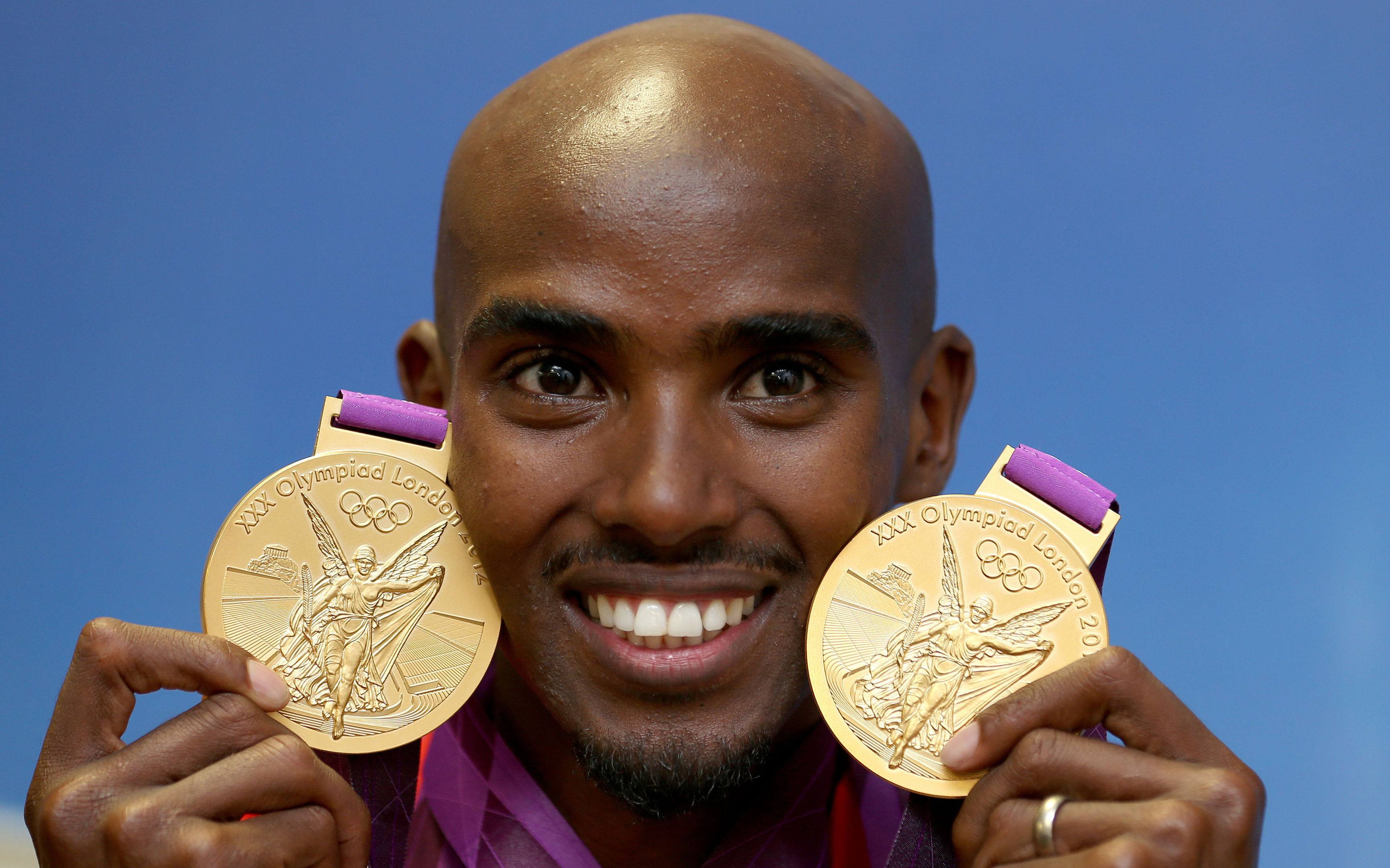 Mo Farah with his two Olympic gold medals he won in the Men's 10,000, and 5,000m.