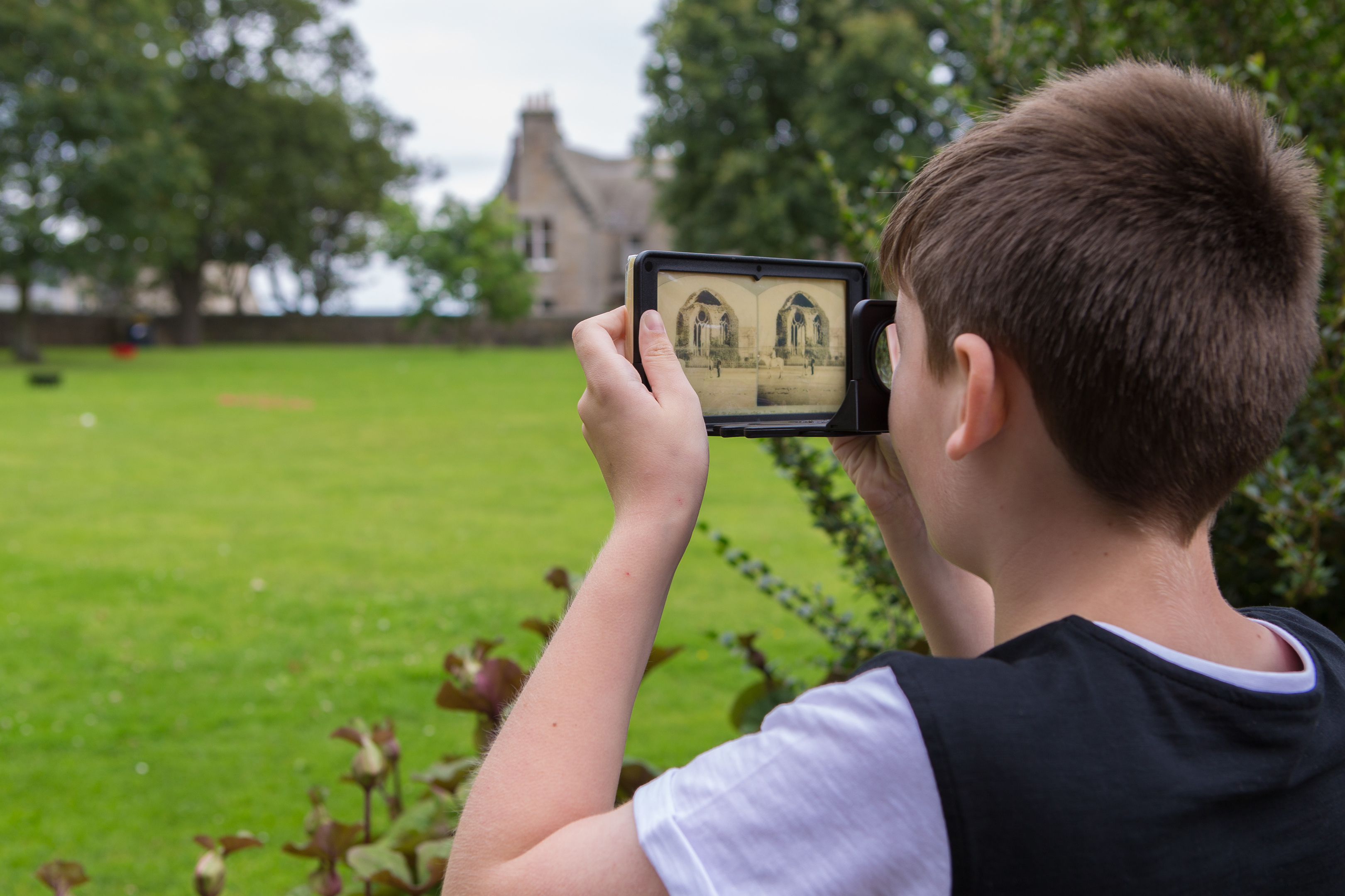 Sam Brown, 10,  visits the Festival of Photography and has a look at the Stereotype Photograph through the glasses which has been printed onto Chocolate, at St Andrews Festival of Photography