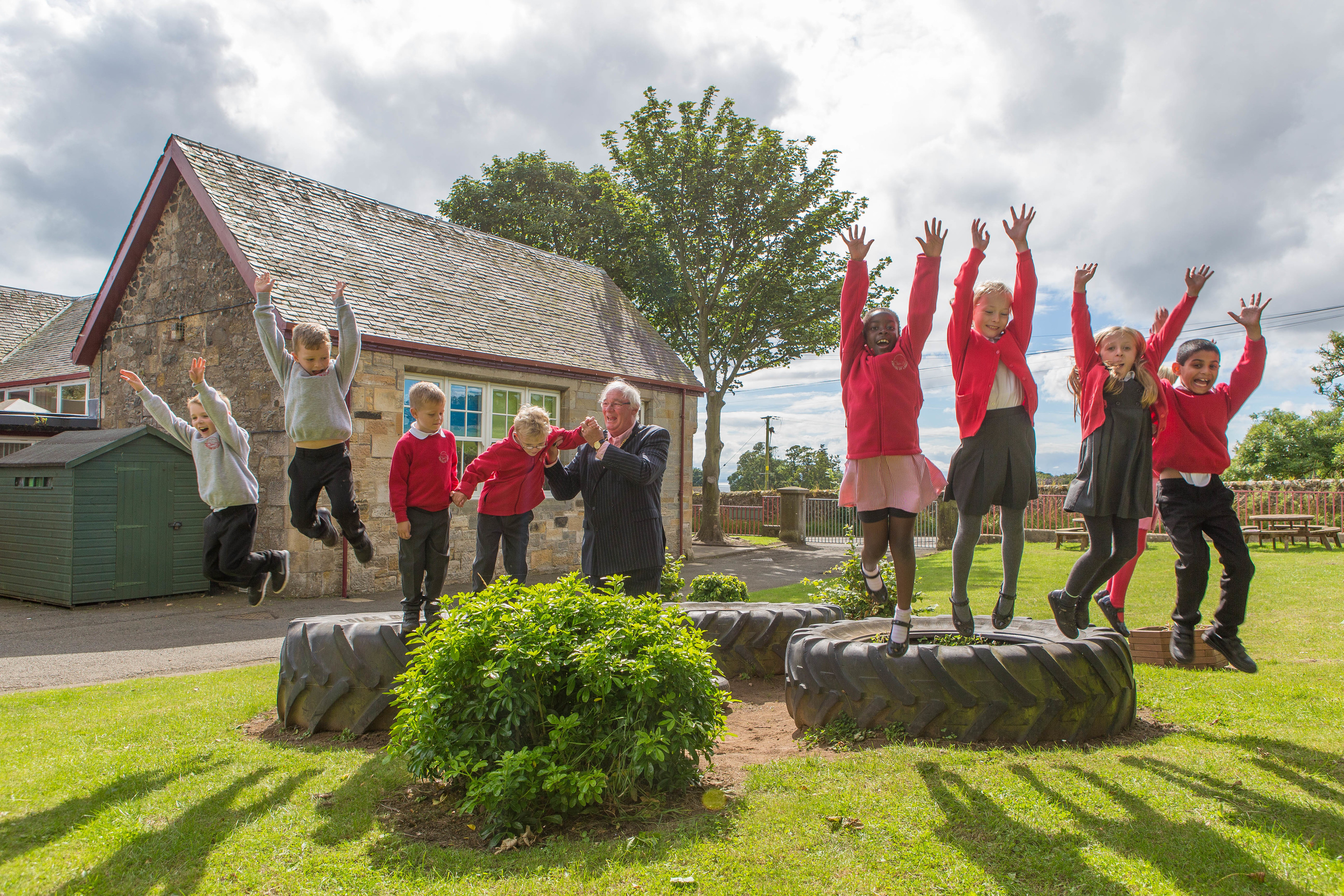 Fife Provost Jim Leishman celebrates the region's happy status with pupils of Kirkton of Largo Primary.