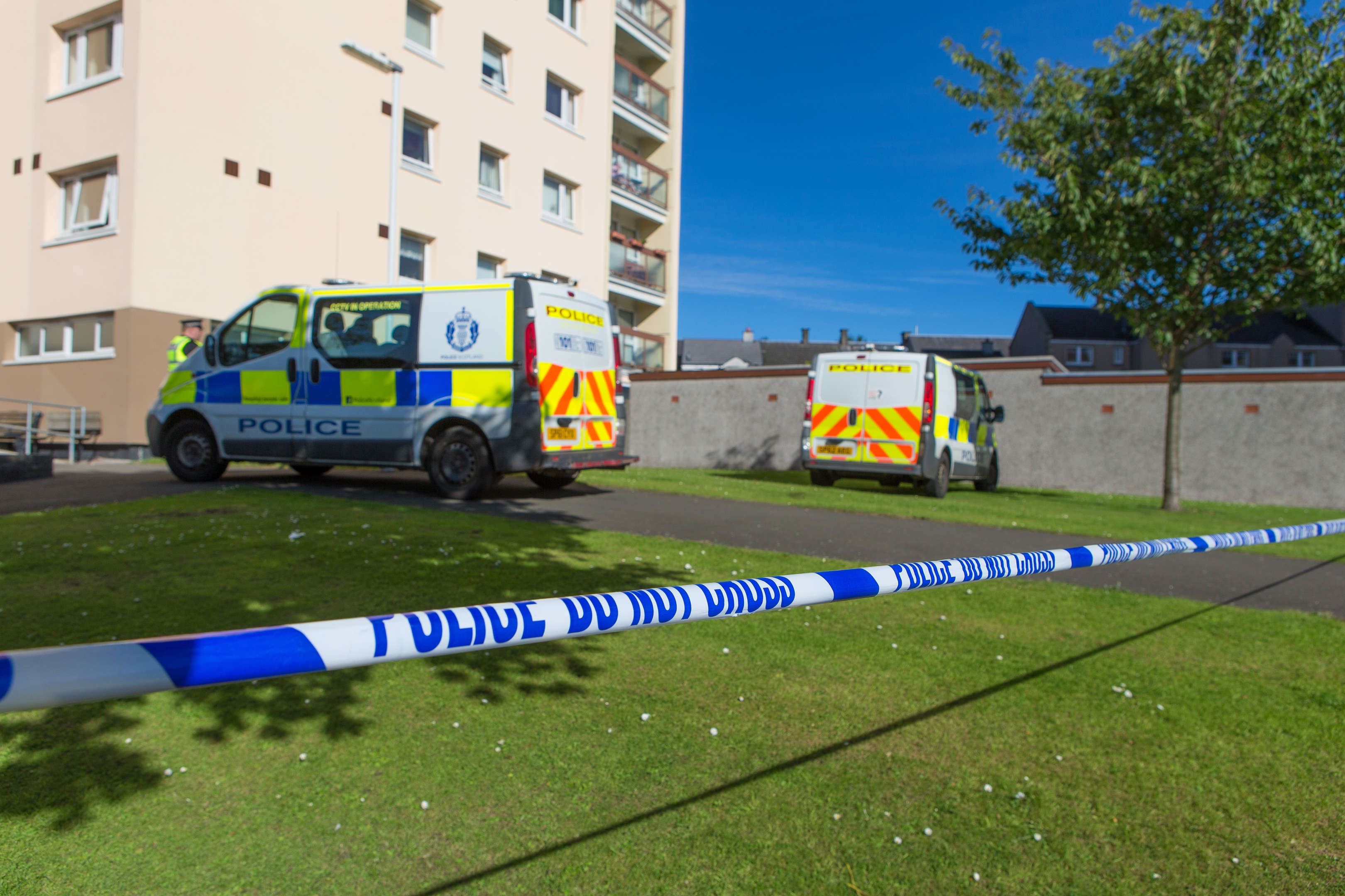 Police at the scene outside Ravens Craig flats.