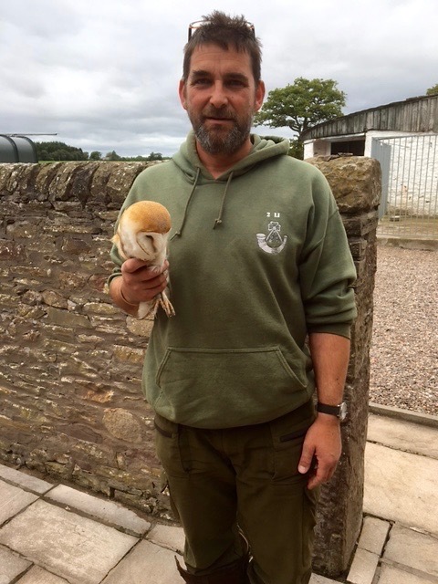 Gamekeeper Jason Clamp with the owl prior to release back into the wild.