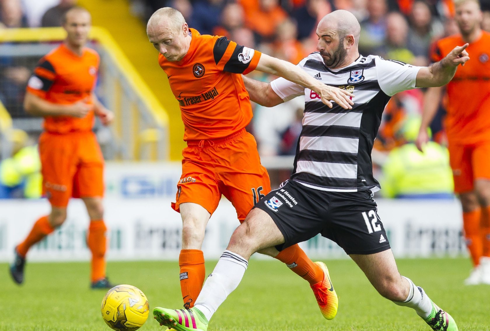 Willo Flood fends off a challenge from Ayr player Gary Harkins.