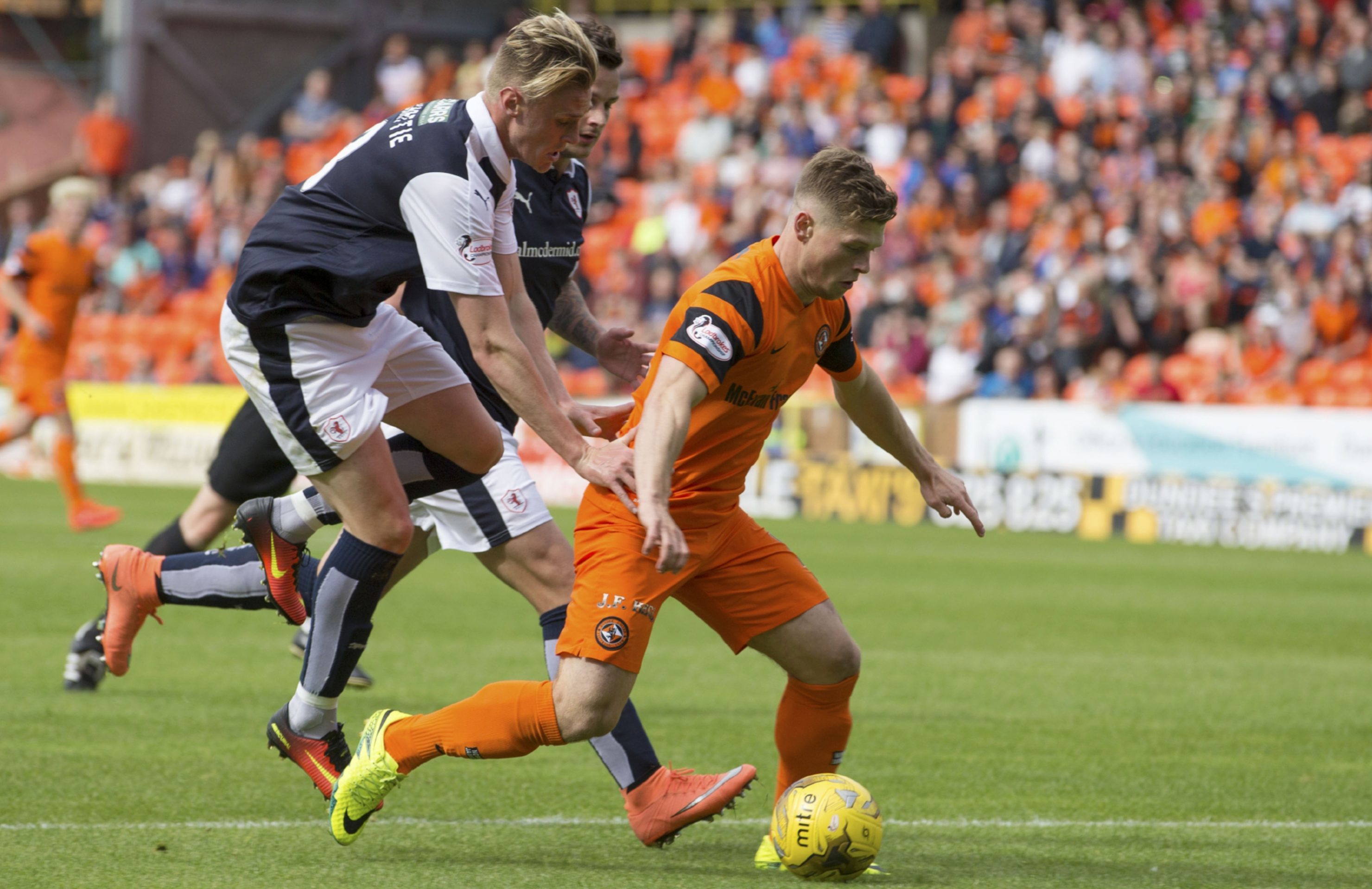 Cammy Smith goes down as he is challenged by Kevin McHattie.