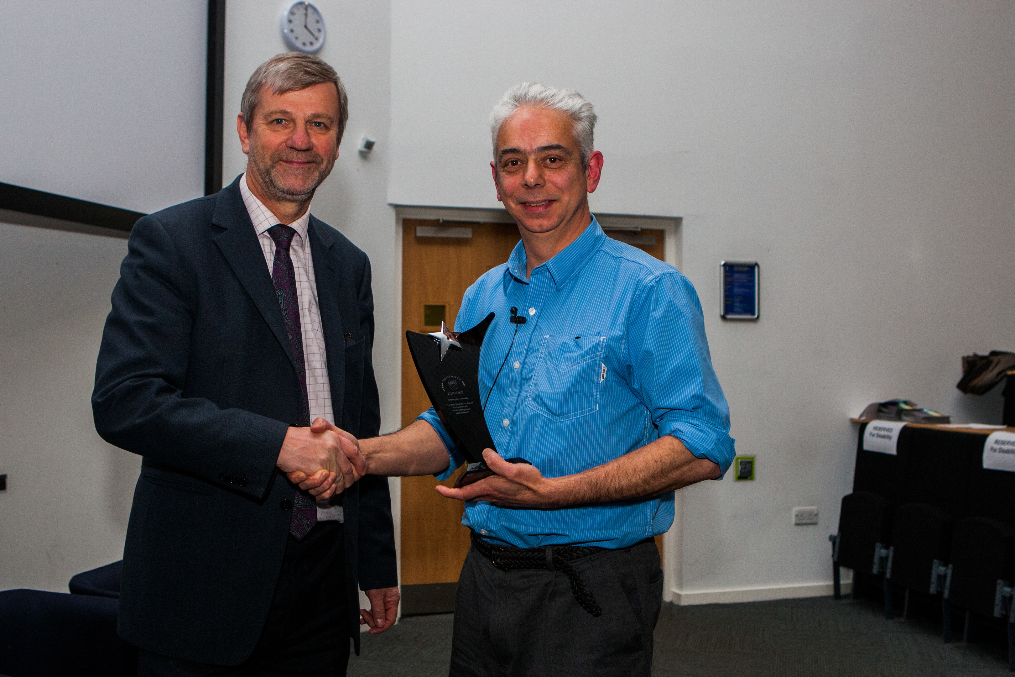 Dr Christopher Connolly (right) receives Dundee University's Stephen Fry Award for Excellence in Public Engagement with Research from Professor Pete Downes last year.