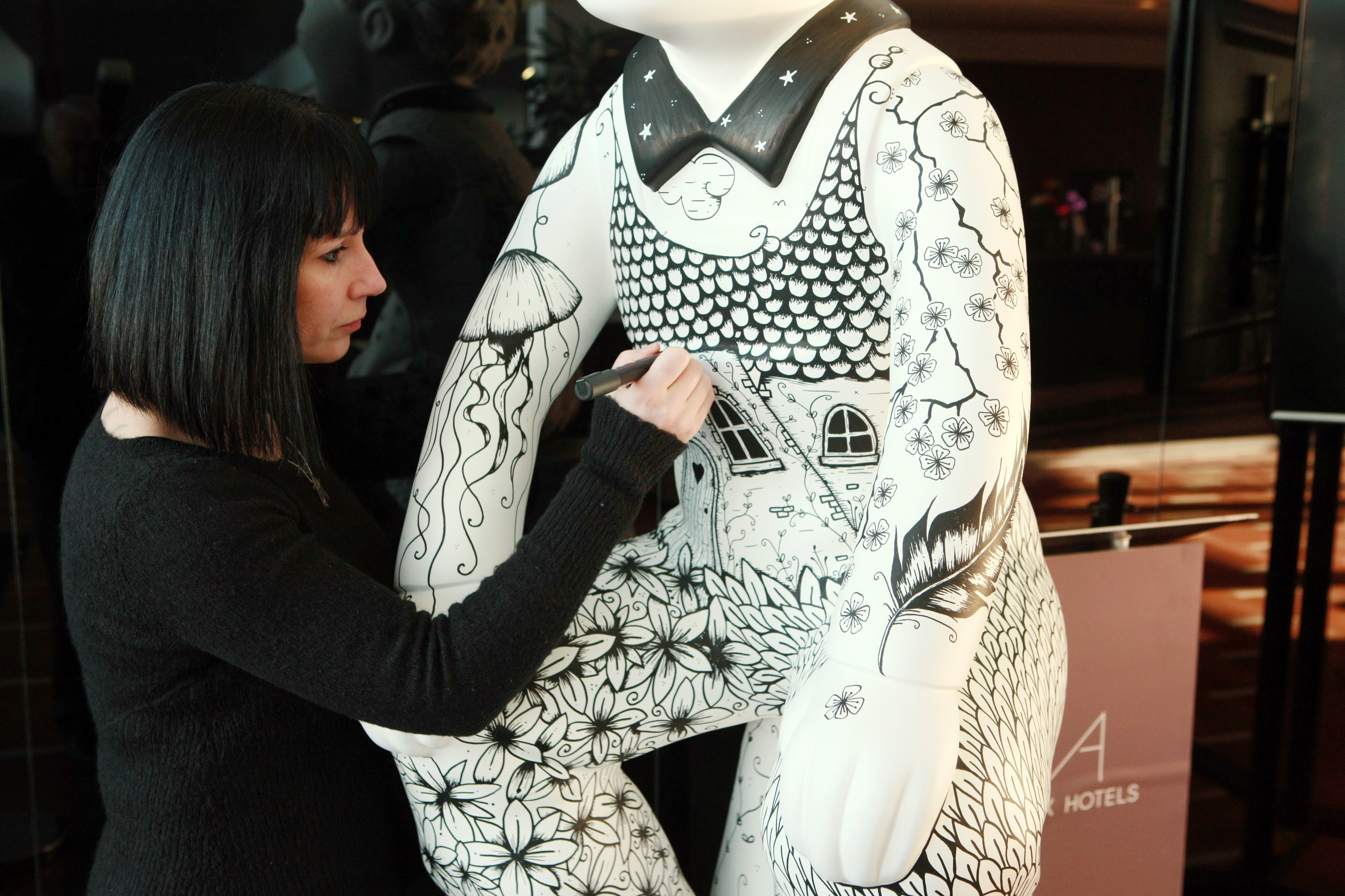 Artist Suzanne Scott with one of her statues.