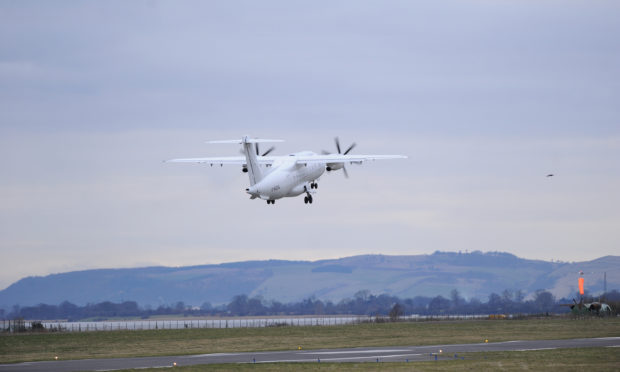 A plane leaves Dundee Airport.