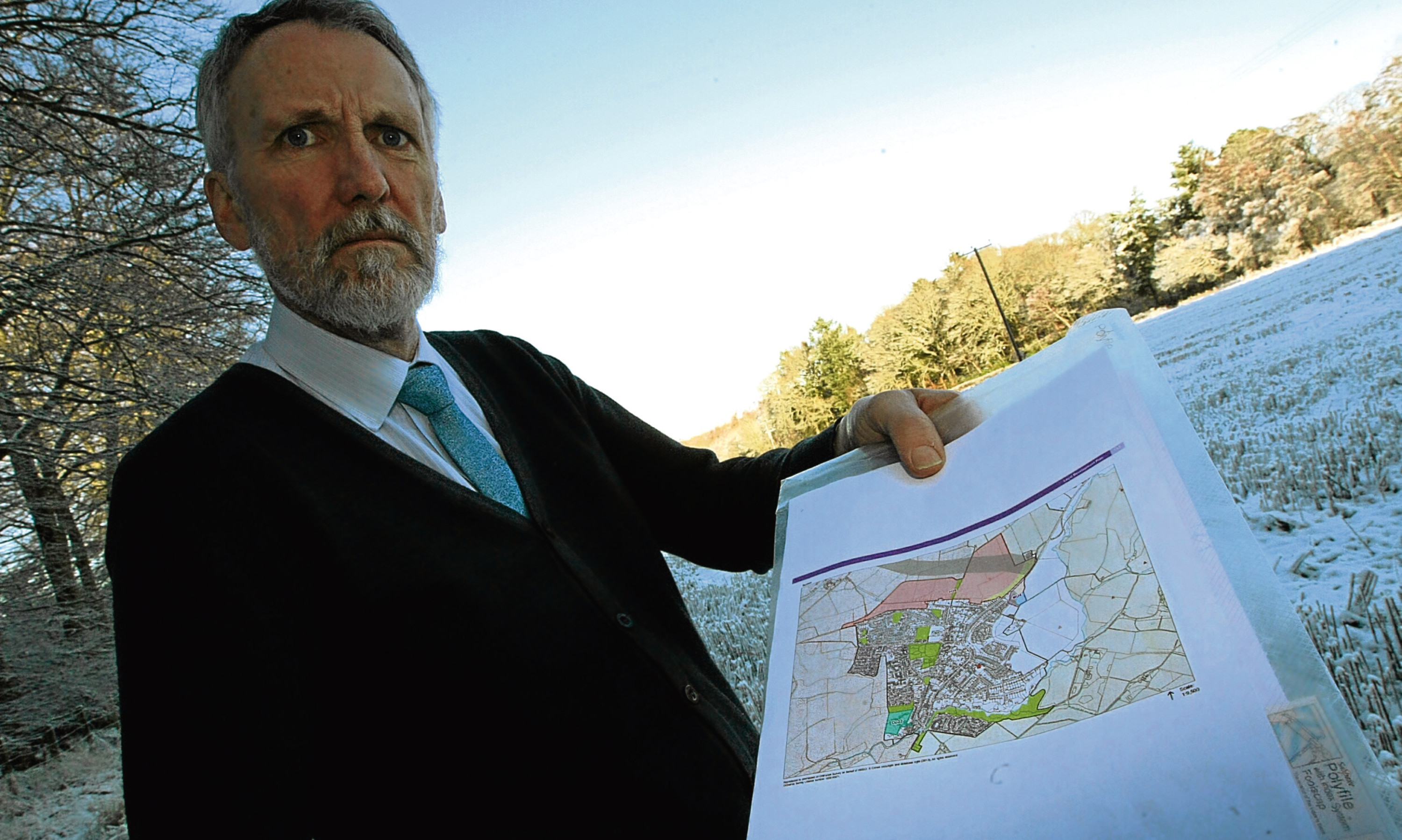 Councillor Lewis Simpson with a map showing the proposed expansion of Scone.