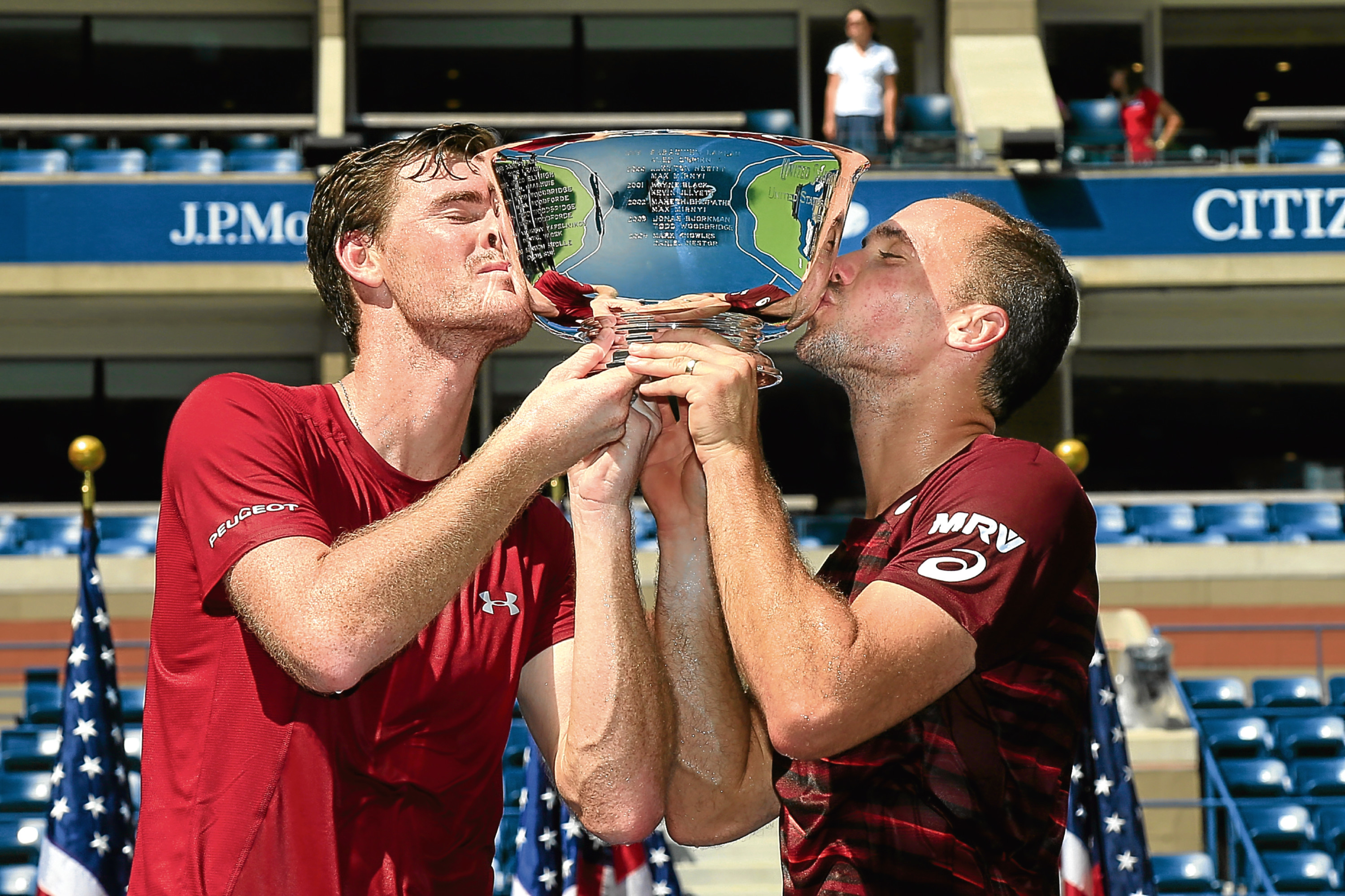 Jamie Murray and Bruno Soares celebrate with the trophy.