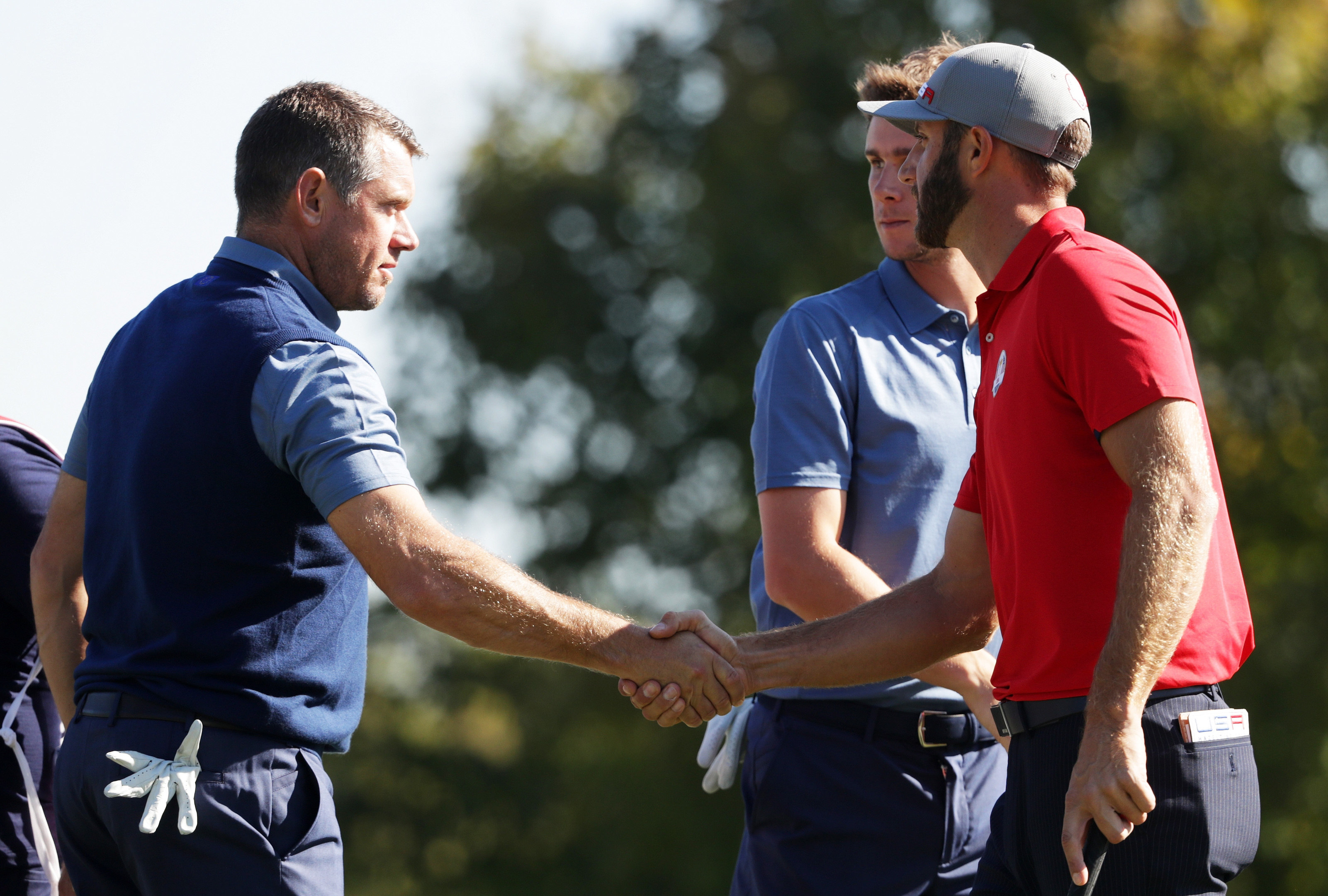 Lee Westwood congratulates Dustin Johnson at the end of their foursomes match at Hazeltine.