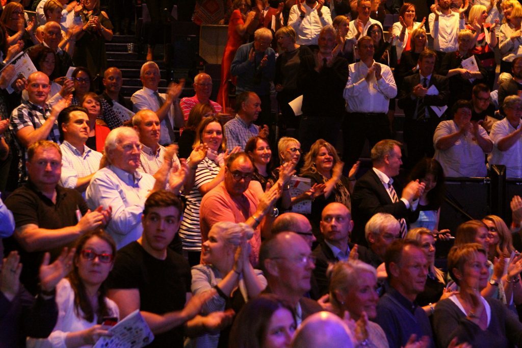 The audience react to the fantastic news that the auction raised £883,000