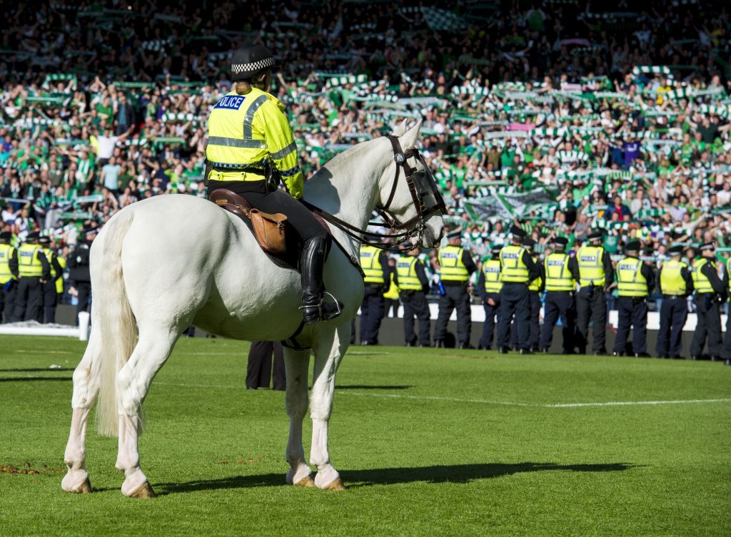 Police line the pitch to push back the Hibernian fans