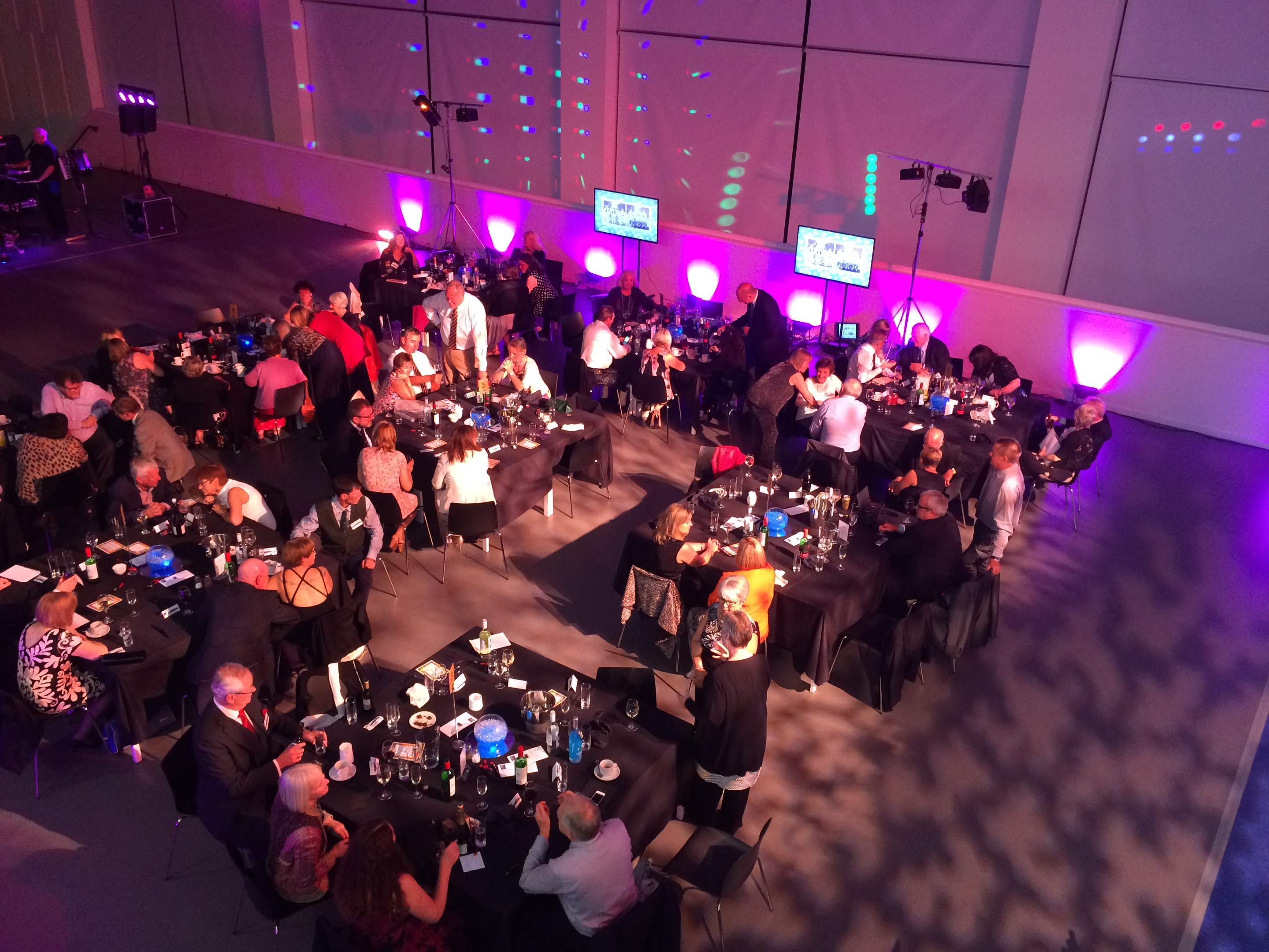 Former Harris Academy pupils enjoying their 50th reunion in the newly built school hall, which was re-purposed for the evening to host a dinner.