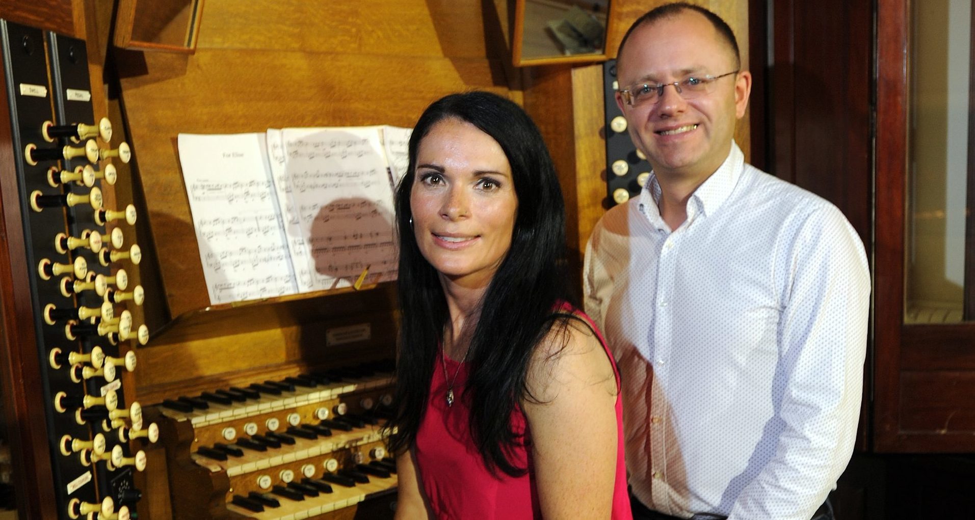 Gayle Ritchie and City Organist Stuart Muir sitting at the Caird Hall organ.