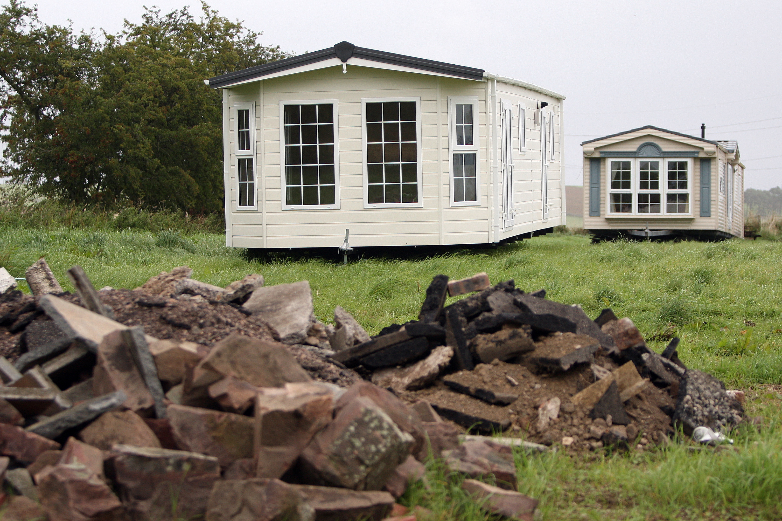 Angus Council is investigating after the arrival of two static caravans in a Tealing field.