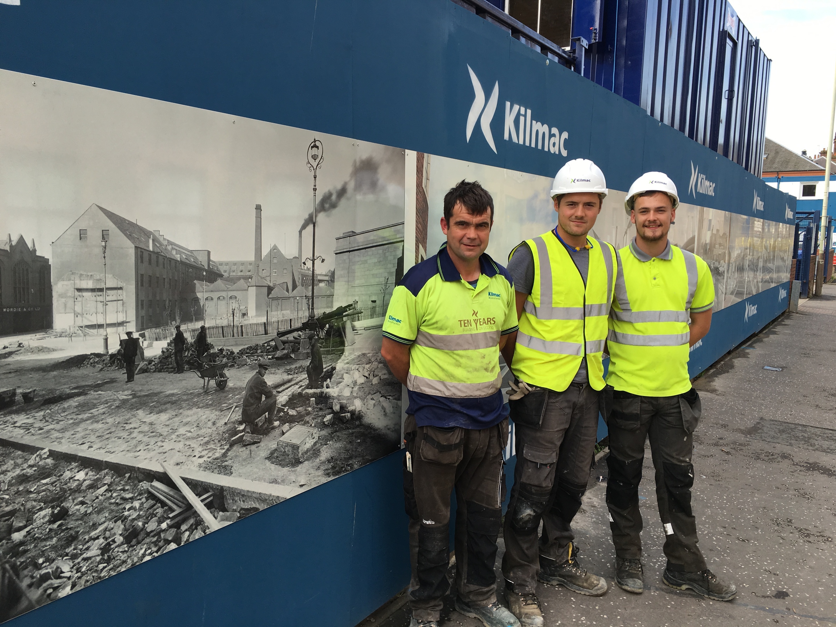 Kilmac foreman Derek Riddoch (left) with Rhys Davies and Dale Burns at the Mill Street hoarding.