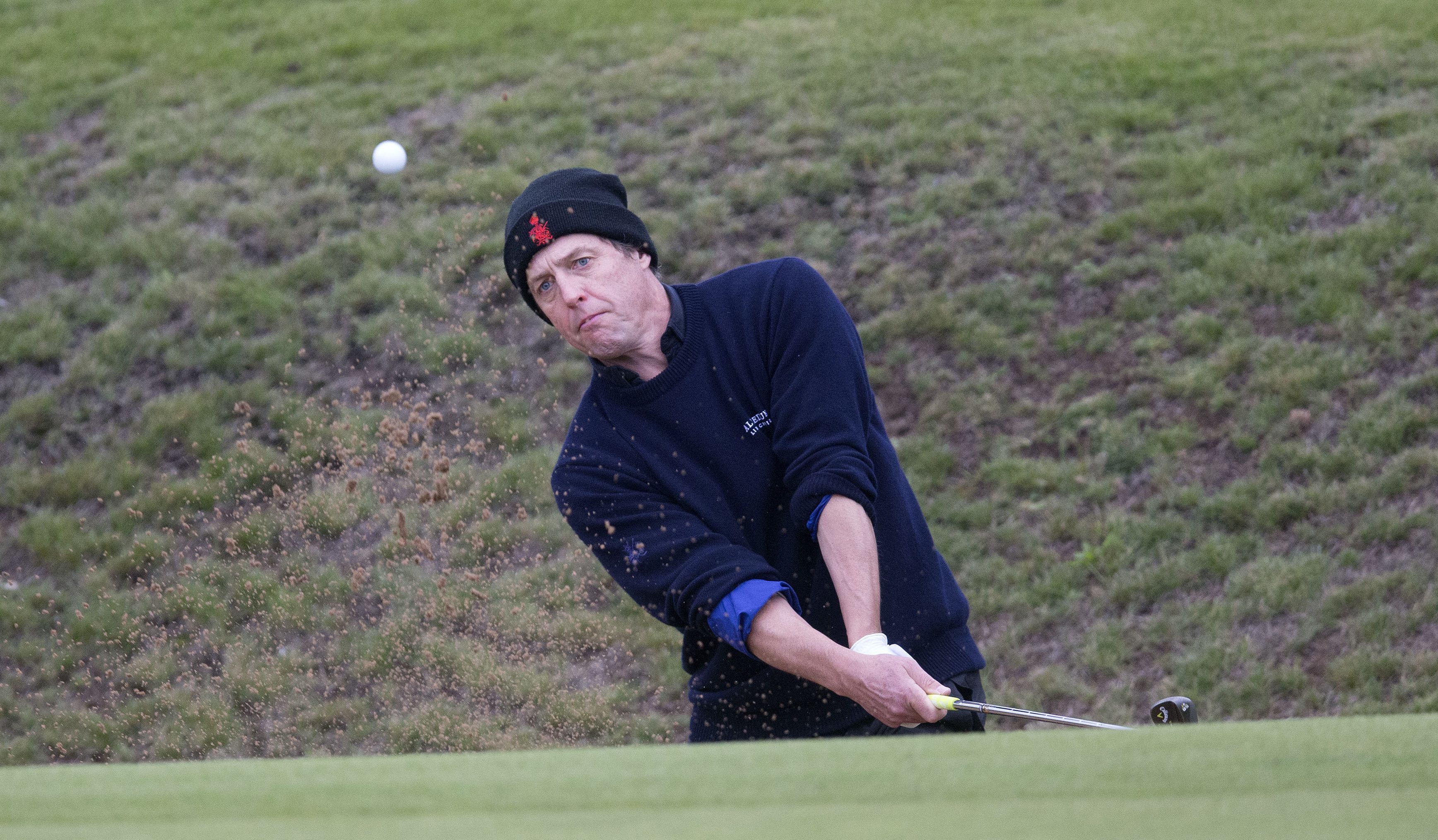 Kingsbarns attracts the stars every year: Hugh Grant plays from the bunker at the 14th during round two of the Alfred Dunhill Links Championship at Kingsbarns Golf course.