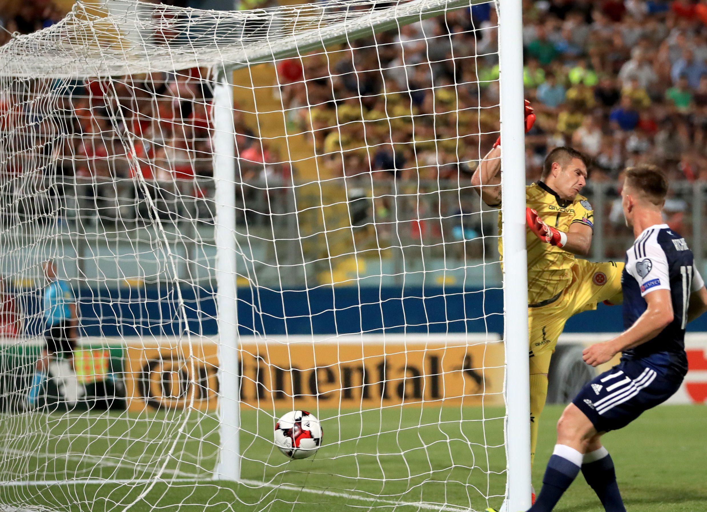 Matt Ritchie watches the cross from Robert Snodgrass find the net for Scotland's opener.