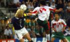 Ex-Scotland captain Colin Hendry clears the ball from Salaheddine Bassir of Morocco at the France 98 World Cup.