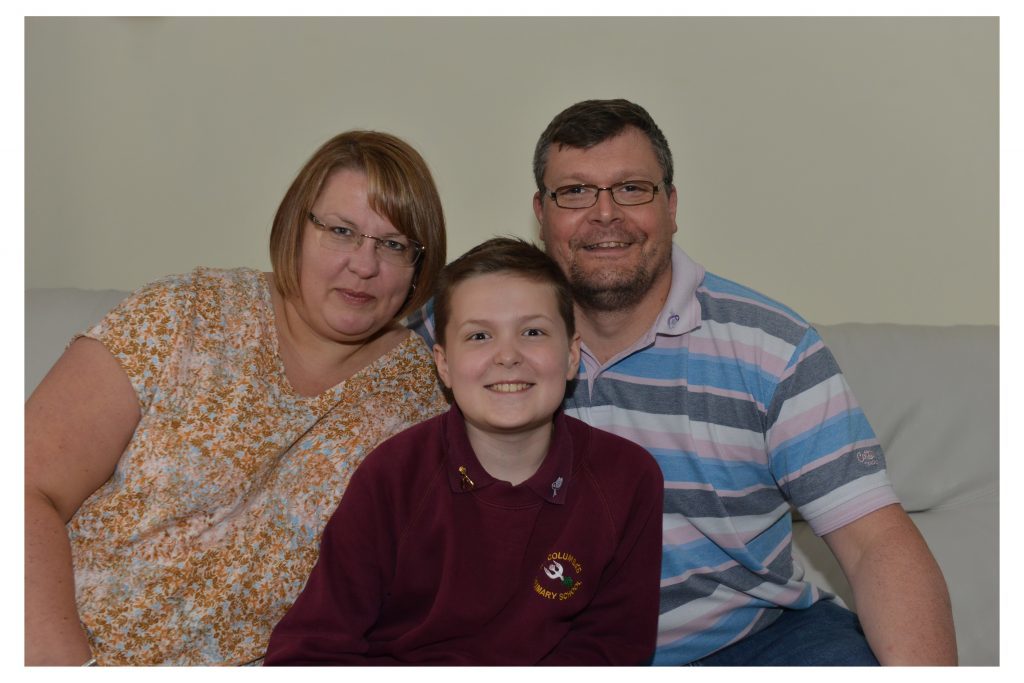 Young cancer battler Toby Etheridge with mum Alison and dad Richie