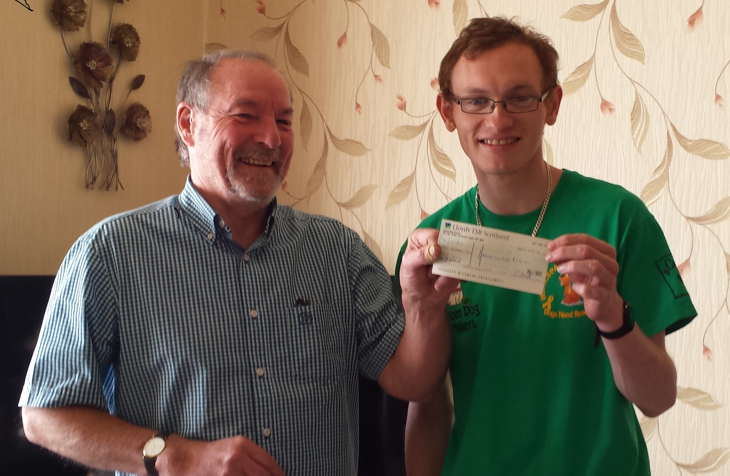 Earlier this year Scott Smith of Carnoustie Canine Capers (right) presented Peter Burke, chair of SAPALD  with a £170 cheque from the proceeds of the car boot sale.