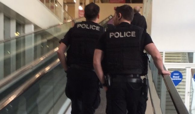 Armed police go shopping in Tesco.