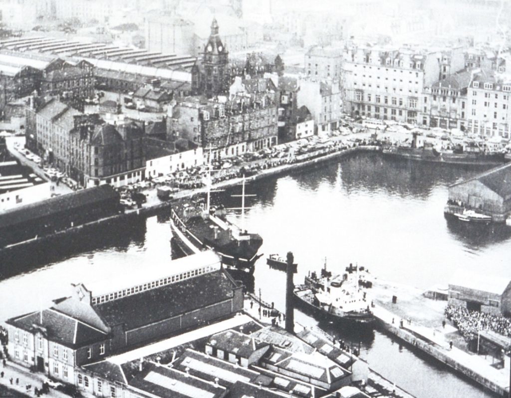 An RAF helicopter provided an aerial perspective as Unicorn moved out of Earl Grey Dock. Few of the buildings in this view survive today.