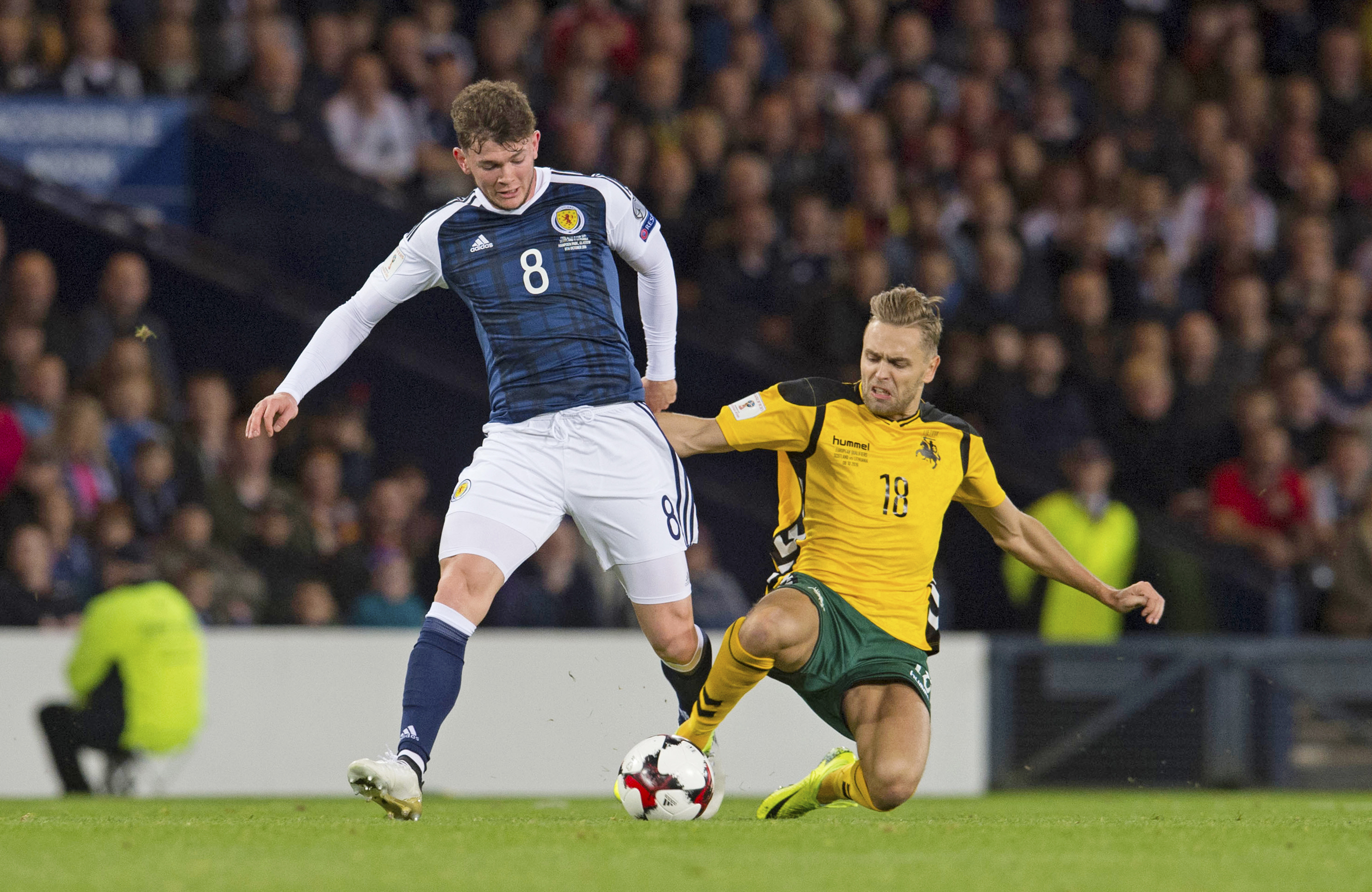 Scotland's Oliver Burke is tackled by Lithuania's Arturas Zulpa.