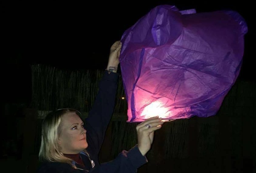 Laura releases a lantern in Kairon's favourite colour, purple.