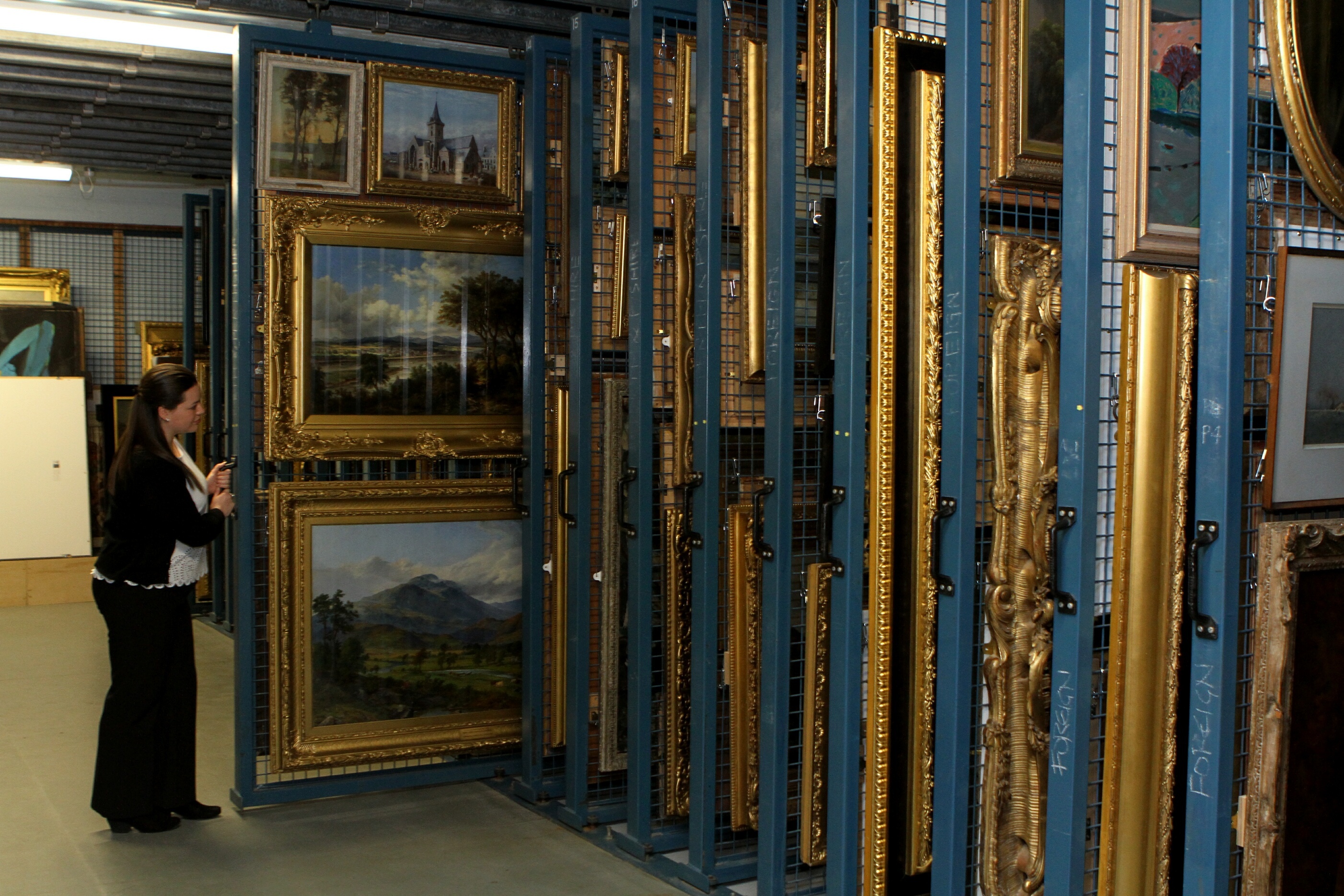 Some of the many paintings stored in the basement