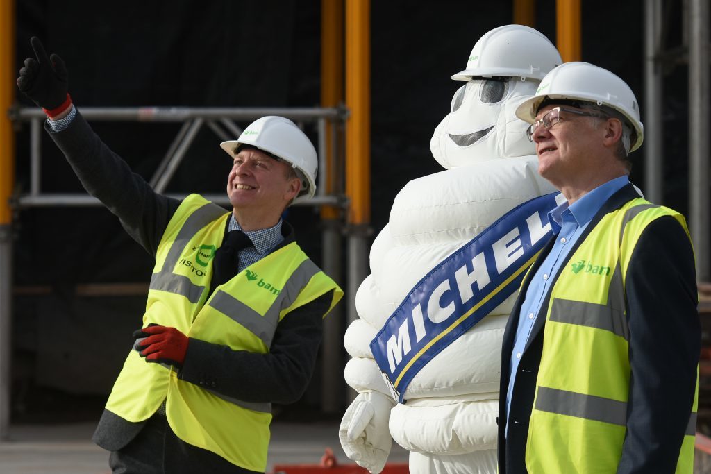 V&A director Philip Long, Michelin factory manager John Reid and Bibendum inspect the construction work from the gallery floor