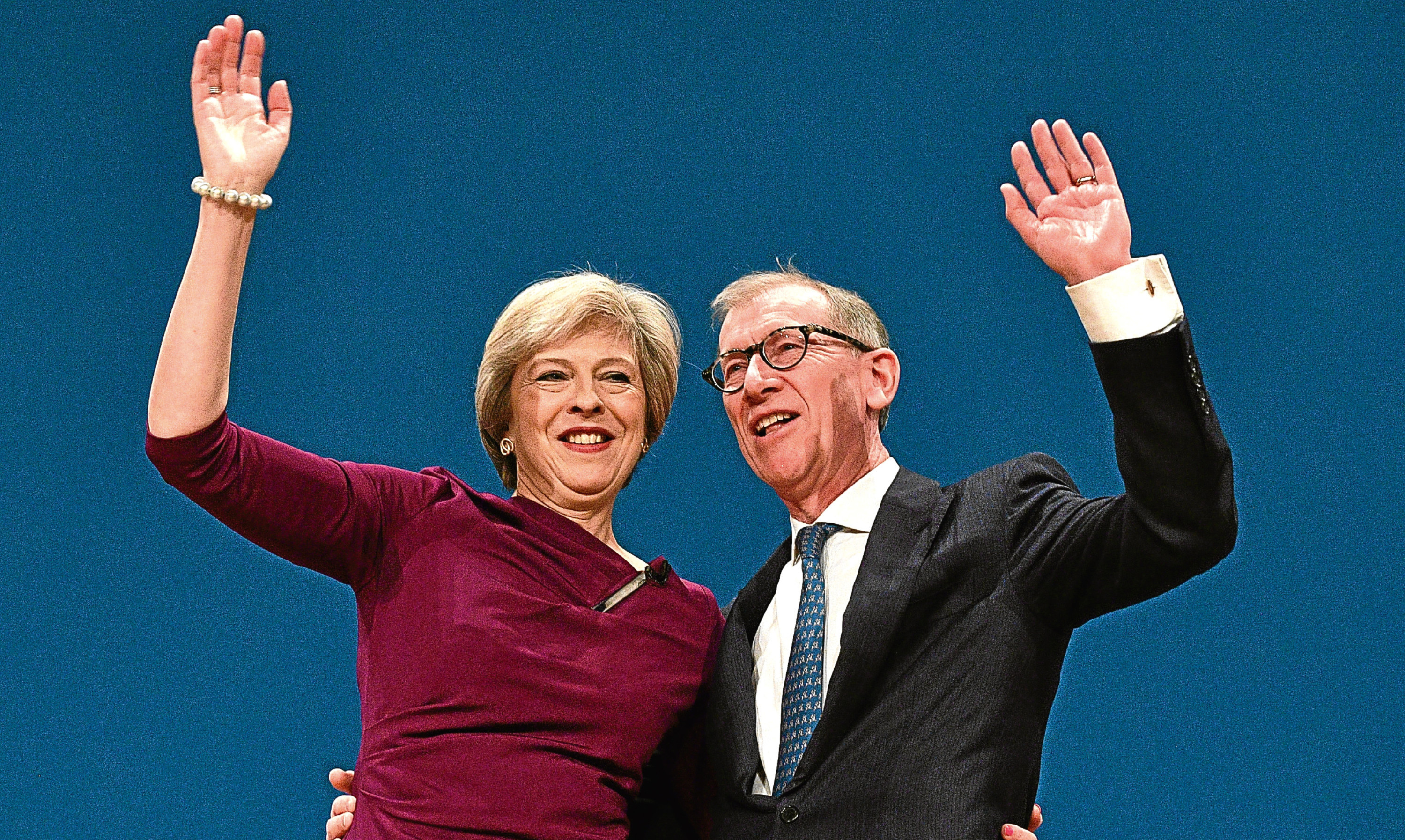 Theresa May and her Husband Philip John embrace after her speech at the Tory Party conference.