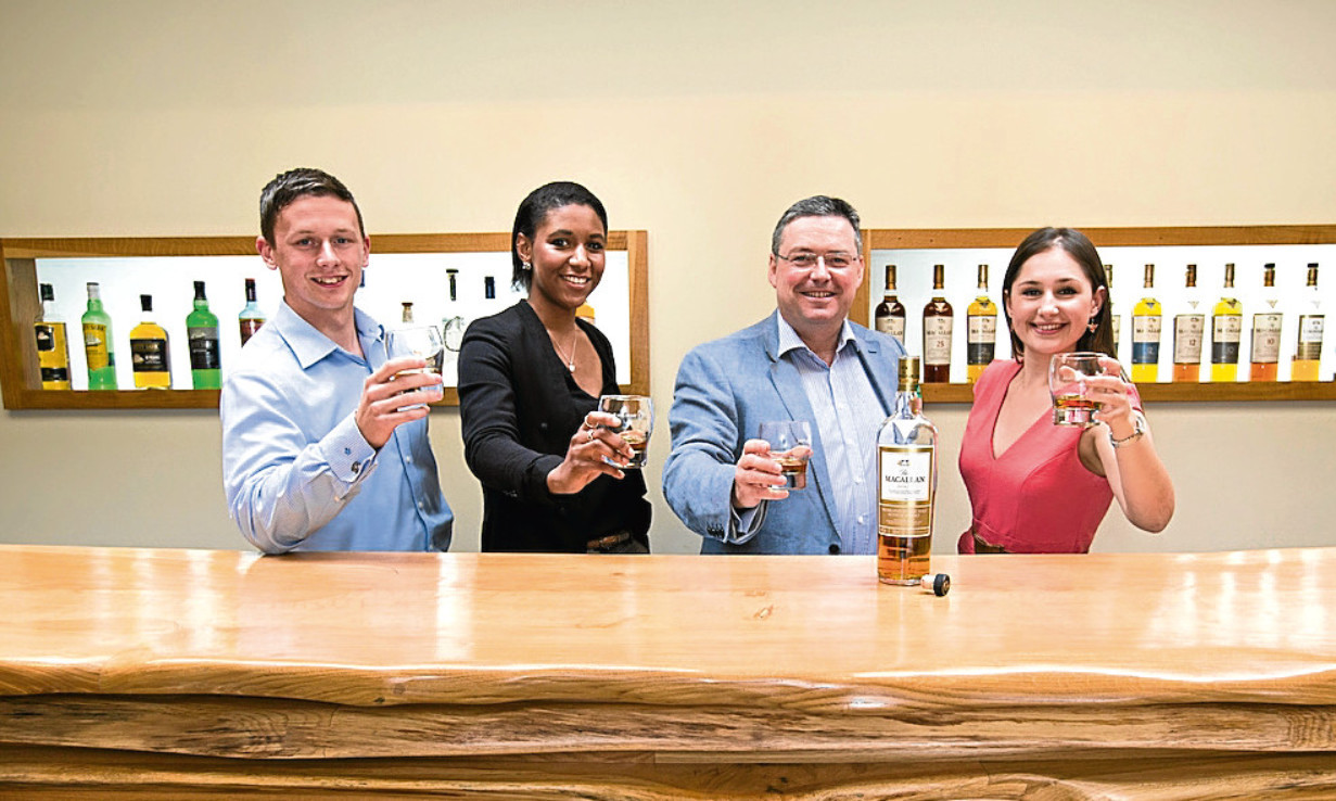 Saltire scholars Scott Barrie, Nadia Fraser and Alice Leyshon raise a dram with The Macallan managing director Scott McCroskie