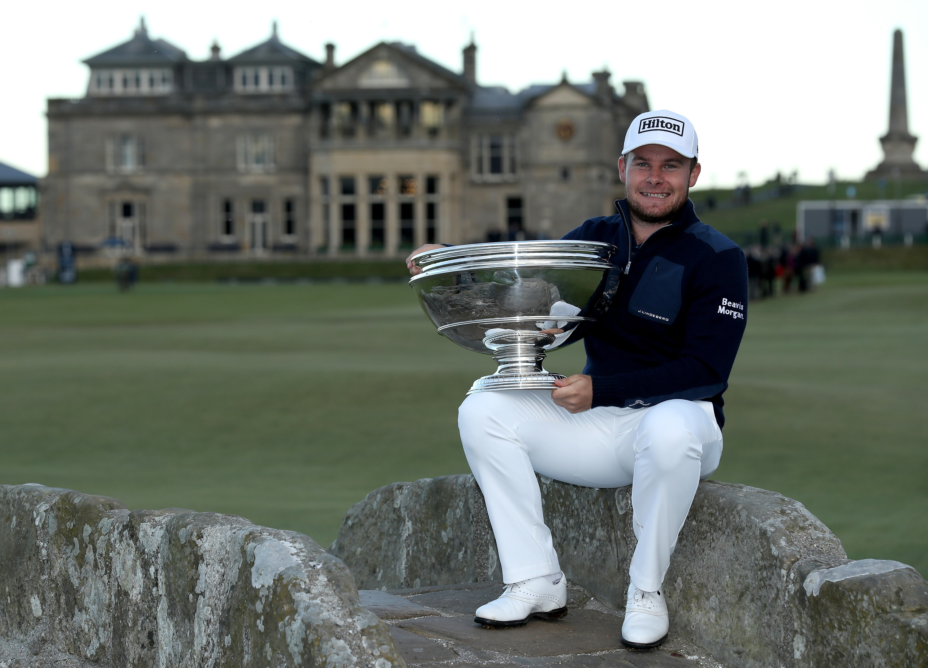Tyrrell Hatton with the Dunhill Links Trophy on the Swilcan Bridge after his vitcory.