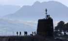 A trident submarine makes it's way out from Faslane Naval base.