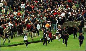 Crowds break through the barriers and stampede down the fairway as Tiger Mania grips the final hole of the 2000 Open at St Andrews