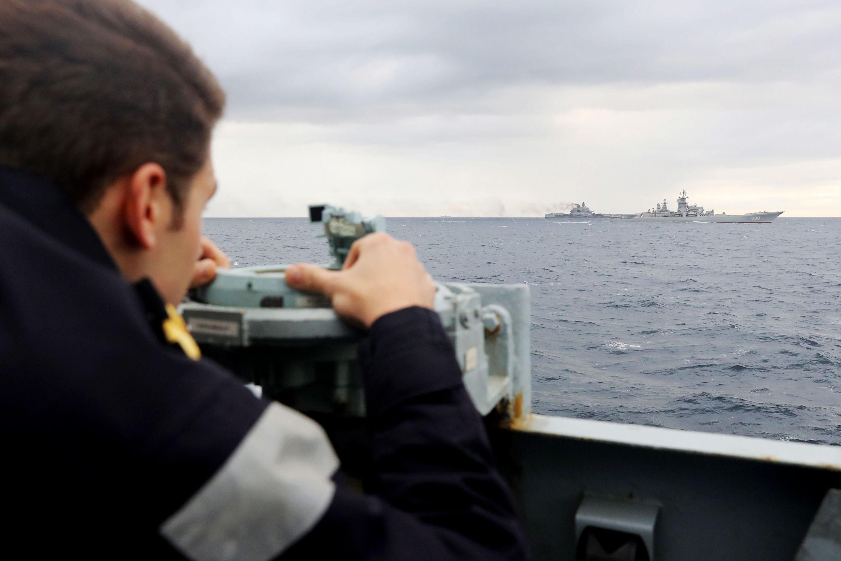 A Royal Navy lookout onboard HMS Richmond observing a Russian task group during transit through the North Sea.