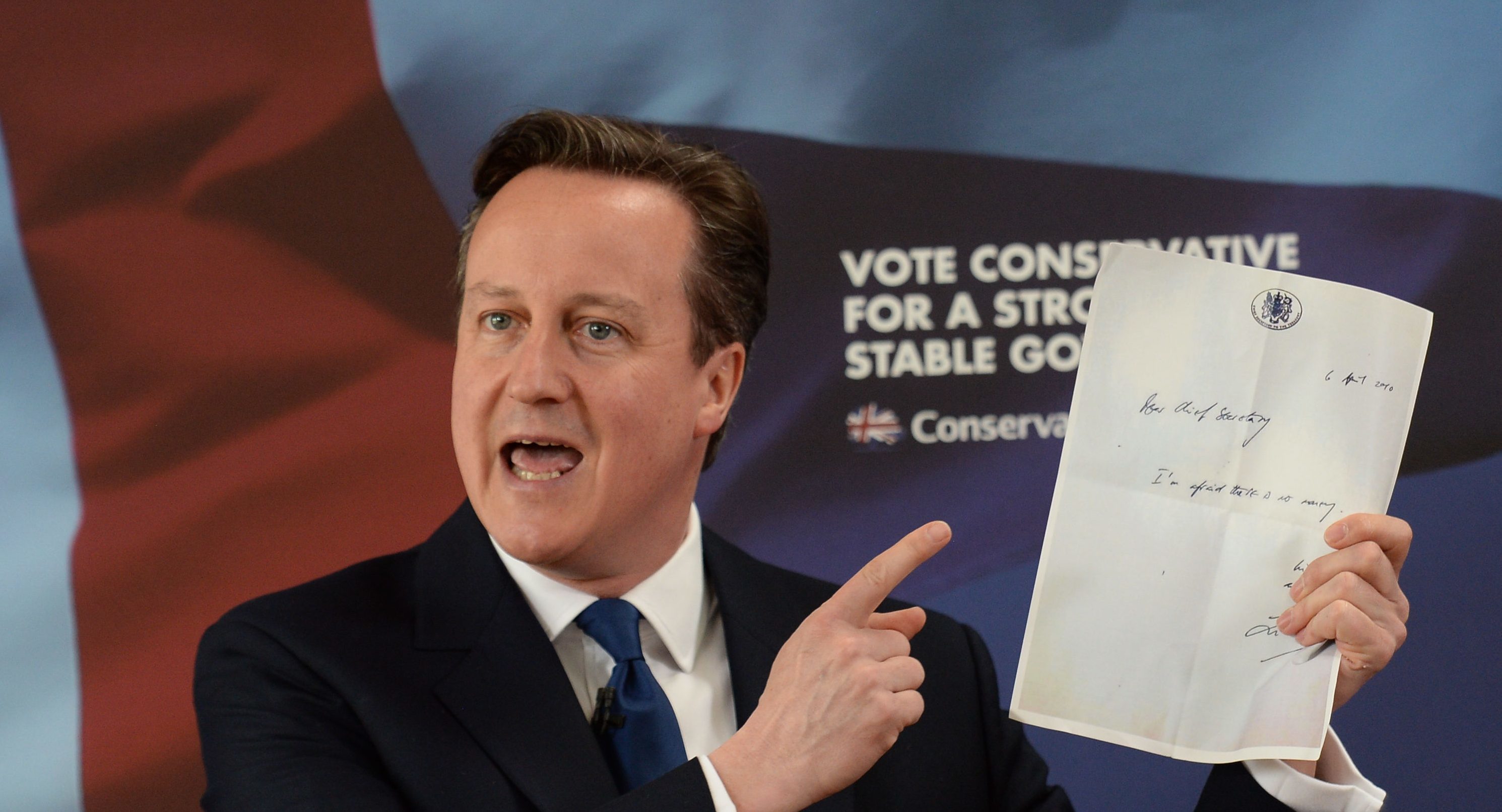 Then-Prime Minister David Cameron holds the notorious "no money" note Liam Byrne left on his Treasury desk after Labour's 2010 election defeat