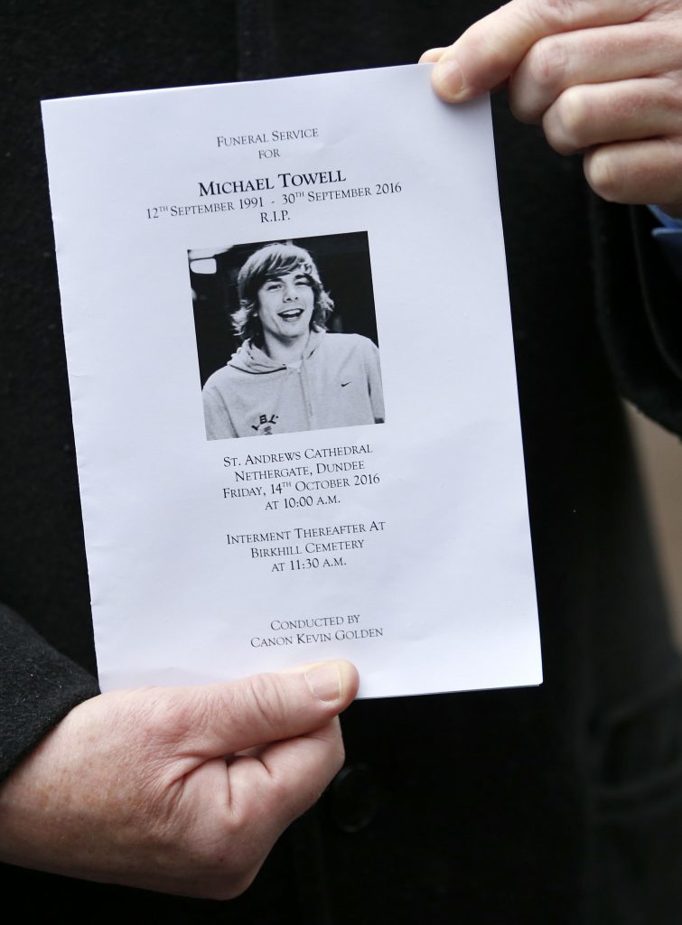 A person holds the order of service ahead of the funeral of boxer Mike Towell at St Andrew's Cathedral, Dundee.