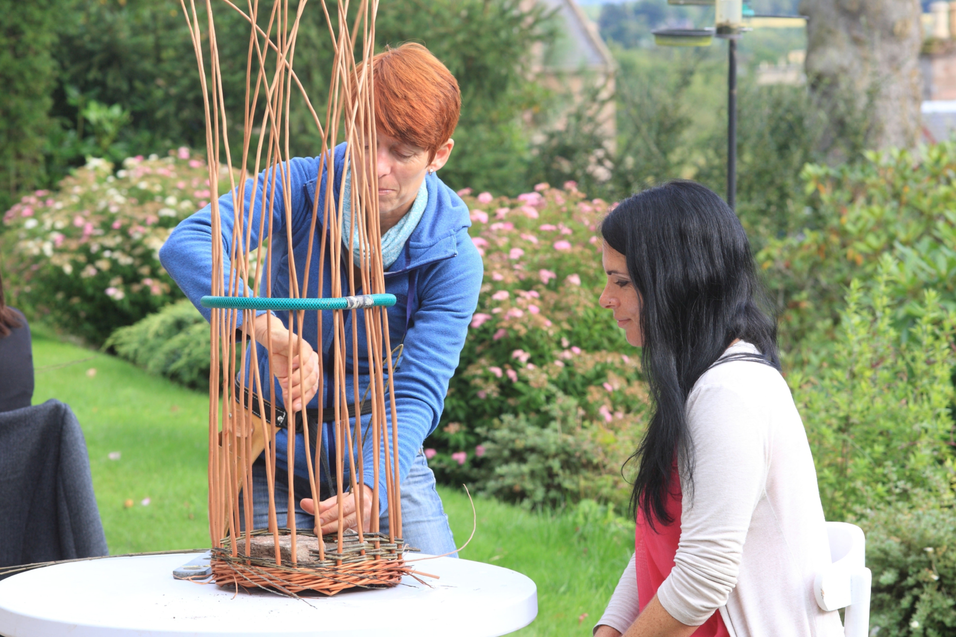 Gayle watches willow weaver Jane Wilkinson in action.