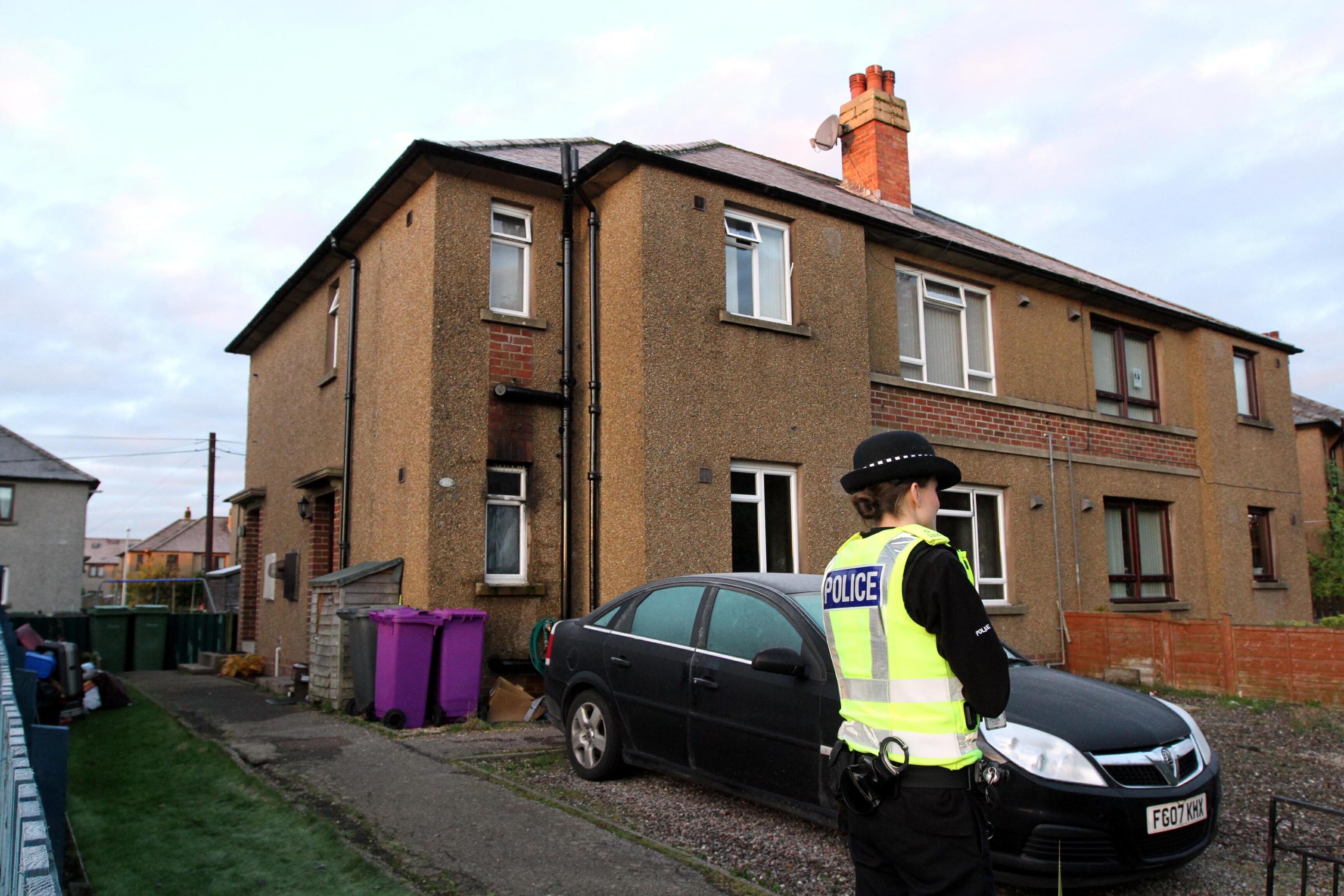 Police outside the fire-hit home.