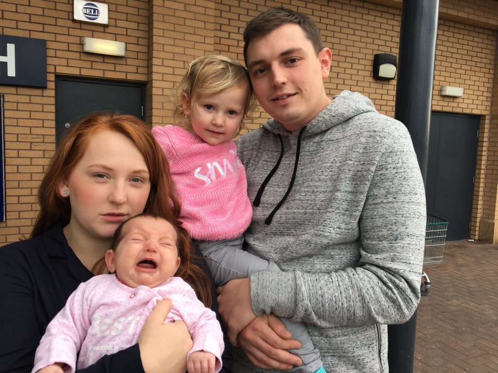 Mum-of-two Chelsea Crook, 24, and her husband Sam, 26, a bus mechanic, of Stockport, Greater Manchester, with their children Abigail, 2, and Hannah, 9 weeks. 