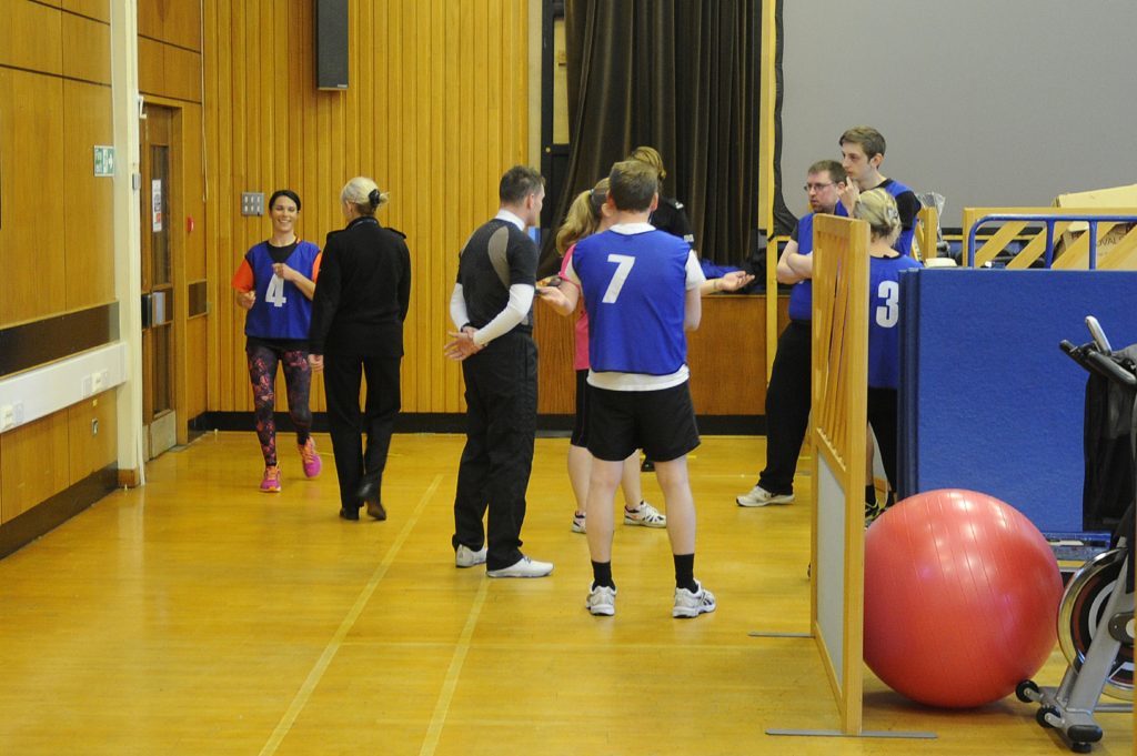 Participants chat among themselves anxiously before the bleep test begins at Forfar Police Station.