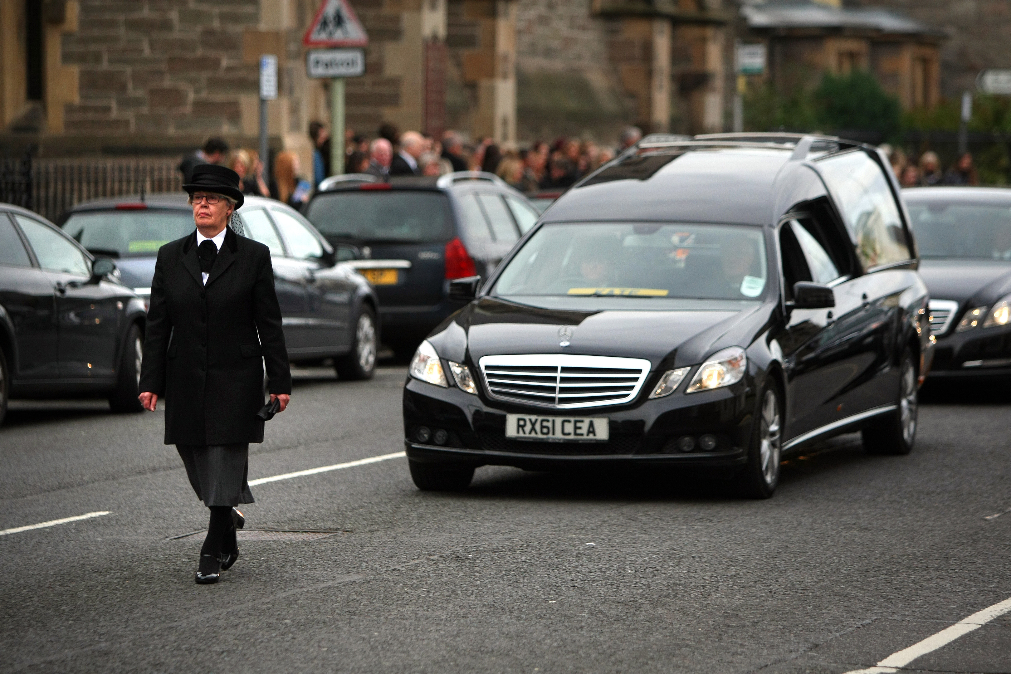 The hearse leaving the church.