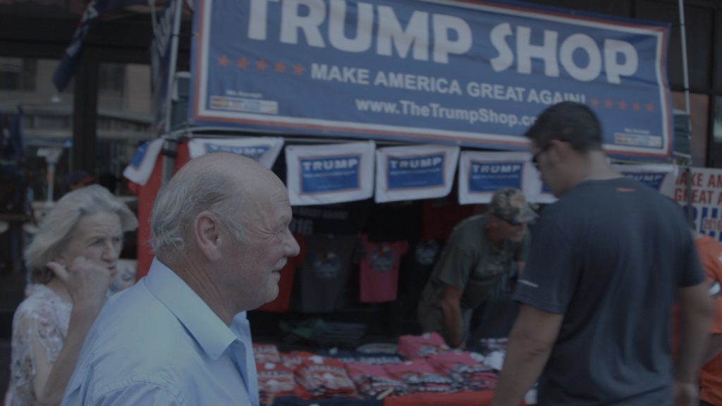 Michael and Sheila Forbes walk by Trump stall during Republican convention in Cleveland Ohio, July 2016