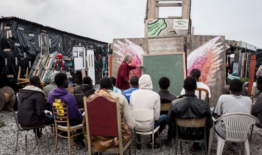A voluntary teacher gives lesson in a school called "Jungle Books" at the refugee camp of Calais also called "The Jungle" in Calais, France September 22, 2016. 