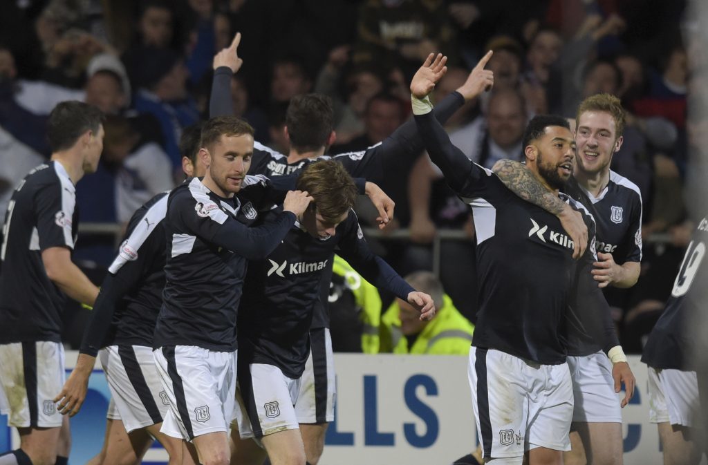 The Dundee players celebrate relegating United.
