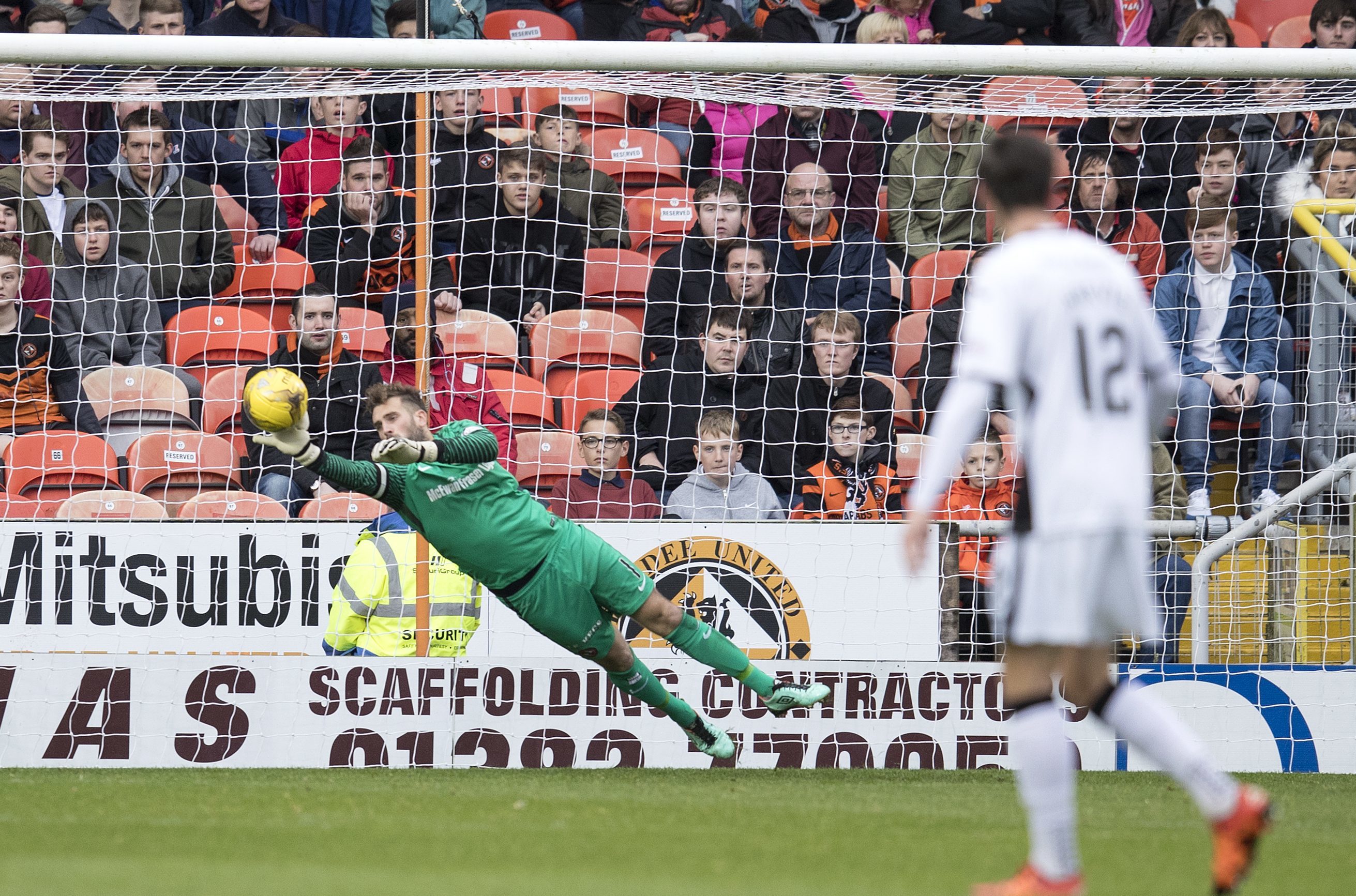 Dundee United keeper Cammy Bell makes a vital save.