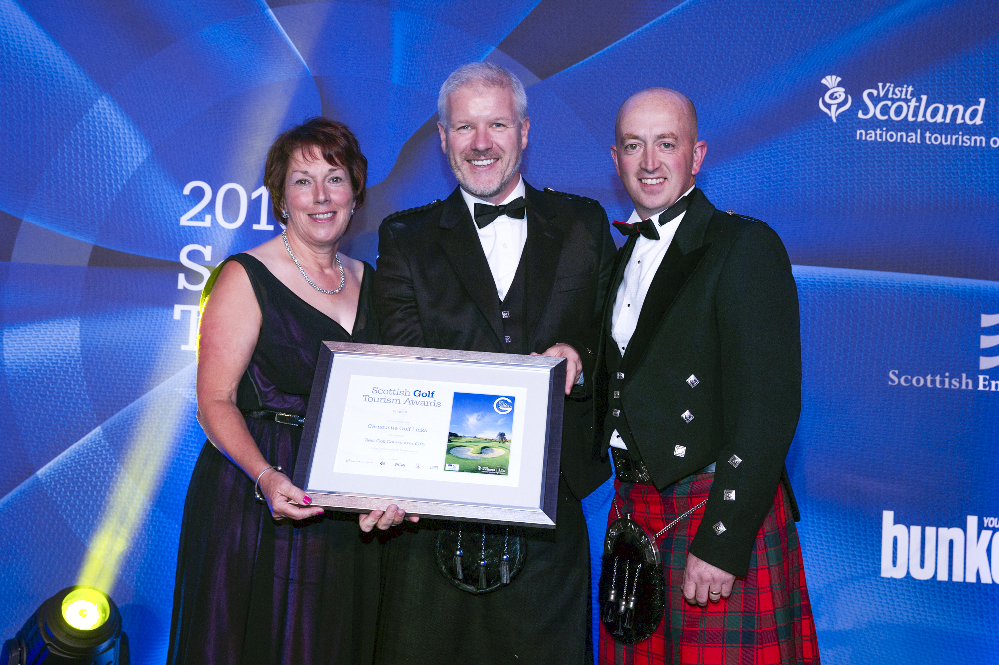 Pat Sawers, Chairman of the CGLMC (far left) and Sandy Reid, Links Superintendent at Carnoustie (far right) receive award from Bunkered magazine’s Tom Lovering (centre).