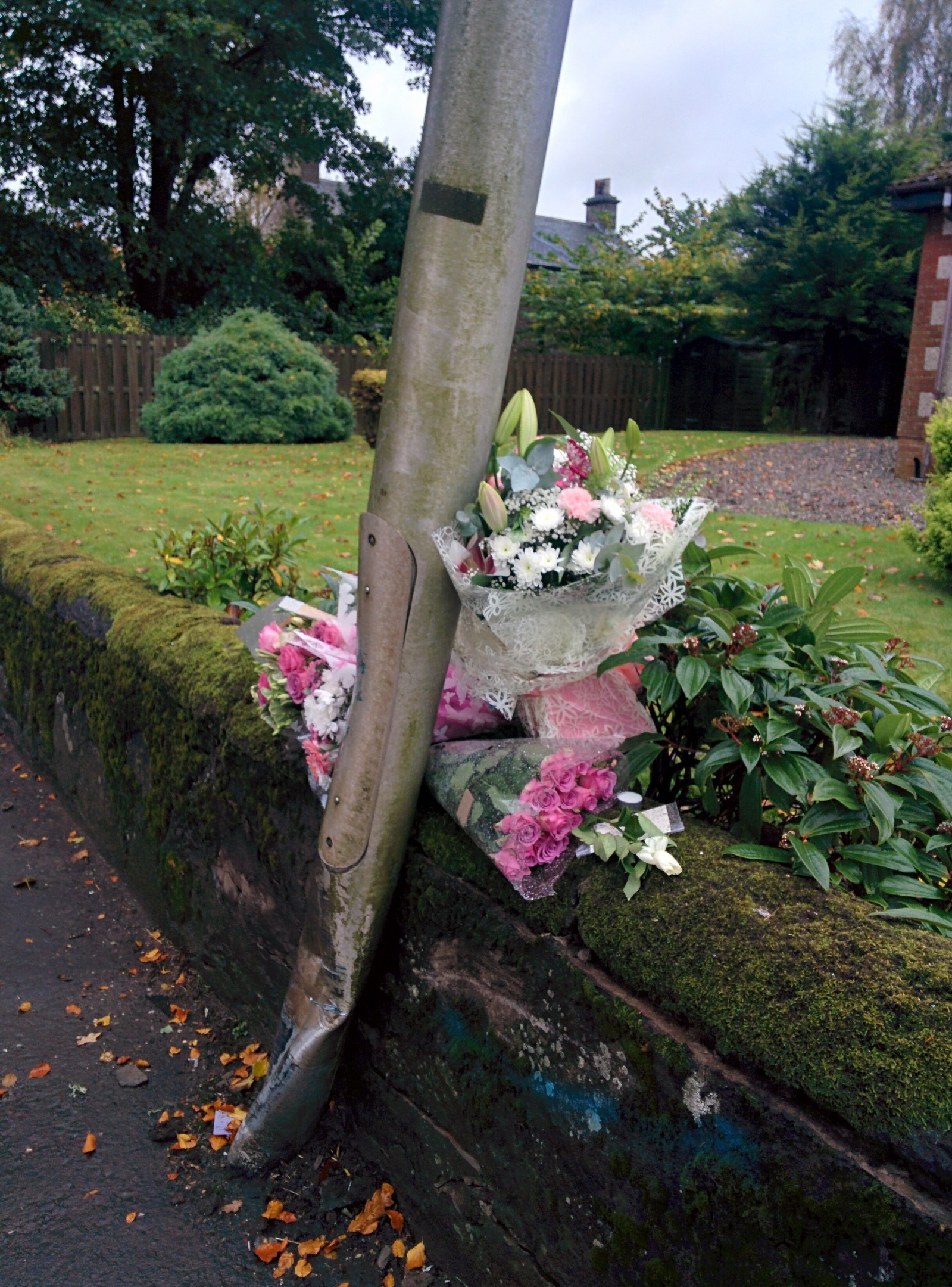 The floral tributes left beside a lampost at the scene of the fatal accident.